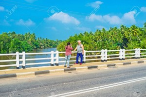 NAINAMADAMA, SRI LANKA - NOVEMBER 25, 2016: The tourists make pictures on Gin Oya bridge and enjoy the views on river and jungles on its banks, on November 25 in Nainamadama.